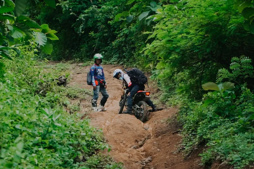 Riders on waterfall and jungle dirt bike trails in Central Lombok